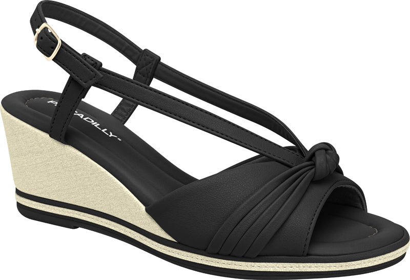 Black wedges sandal by Piccadilly featuring ab adjustable strap with a gold buckle, front knot detail, and a sole with black and withe stripes.