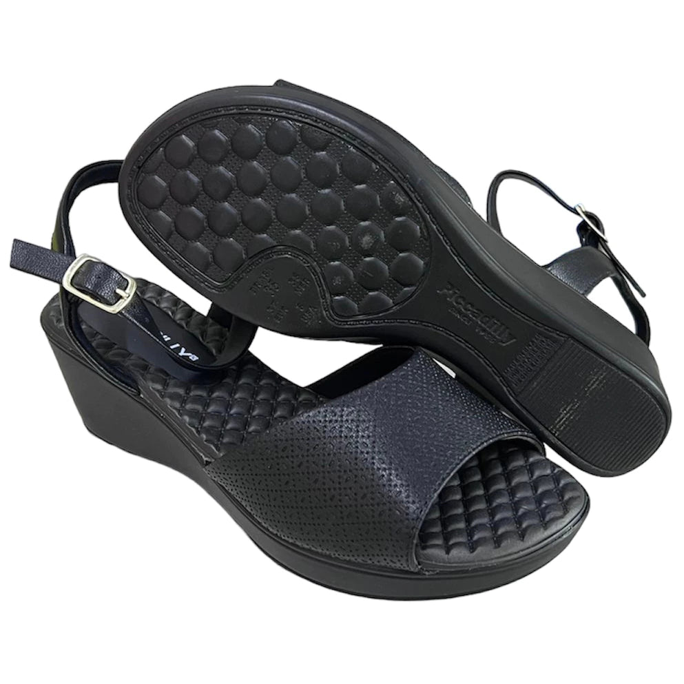 Piccadilly sandal with medium flat heel in black featuring a soft, cushioned insole. it has an adjustable buckle at the heel.