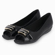 Piccadilly flat shoe with low heel, black color, featuring a buckle with gold and black patent details.