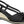 Black wedges sandal by Piccadilly featuring ab adjustable strap with a gold buckle, front knot detail, and a sole with  black and withe stripes.