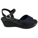 Piccadilly sandal with medium flat heel in black featuring a soft, cushioned insole. it has an adjustable  buckle at the heel.
