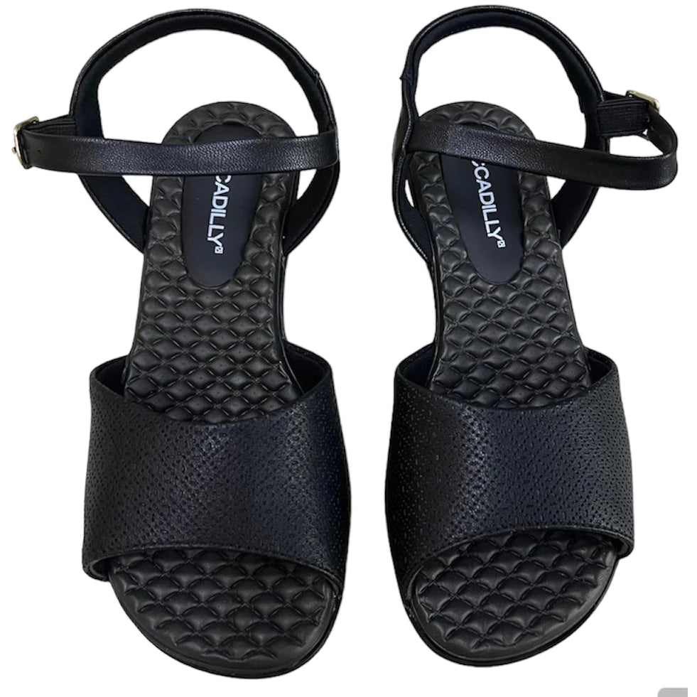 Piccadilly sandal with medium flat heel in black featuring a soft, cushioned insole. it has an adjustable  buckle at the heel.