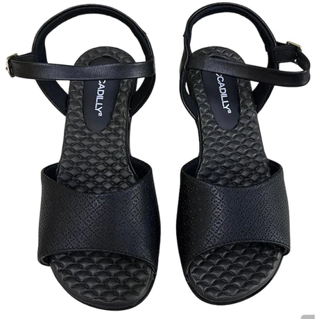 Piccadilly sandal with medium flat heel in black featuring a soft, cushioned insole. it has an adjustable  buckle at the heel.